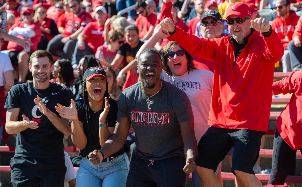 University of Cincinnati Alumni cheering at the Homecoming football game