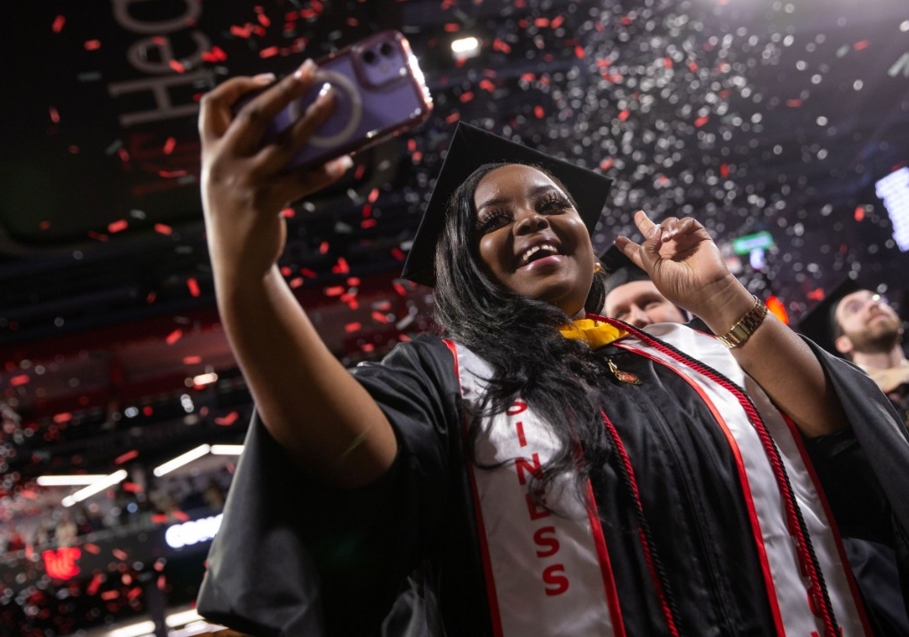 alumni taking a selfie at commencement