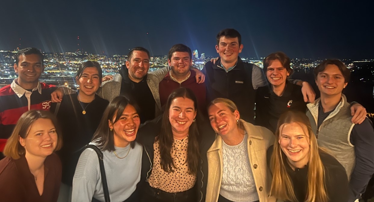 A group of students smiling at a Dinner With Bearcats event