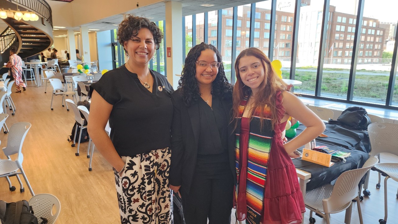 three women smiling in a classroom