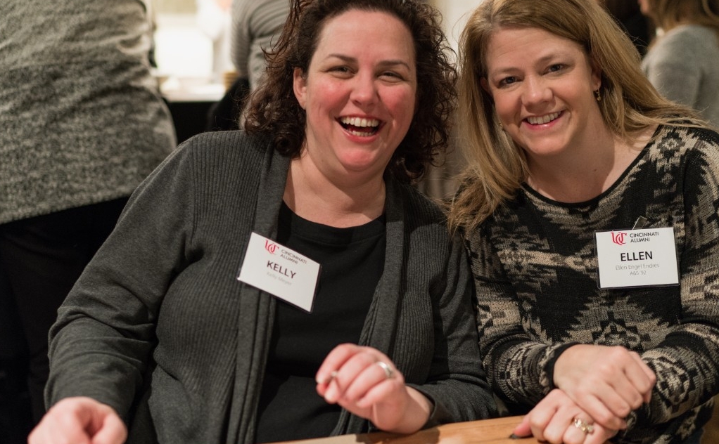 Two women smile for a photo together at an event