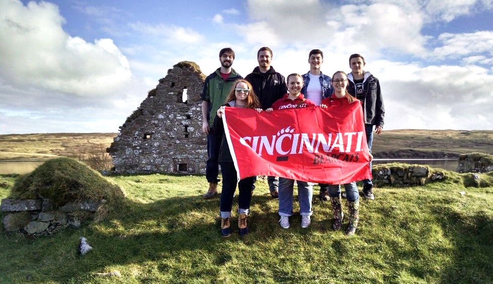 Bearcats students in Scotland pose with a UC flag